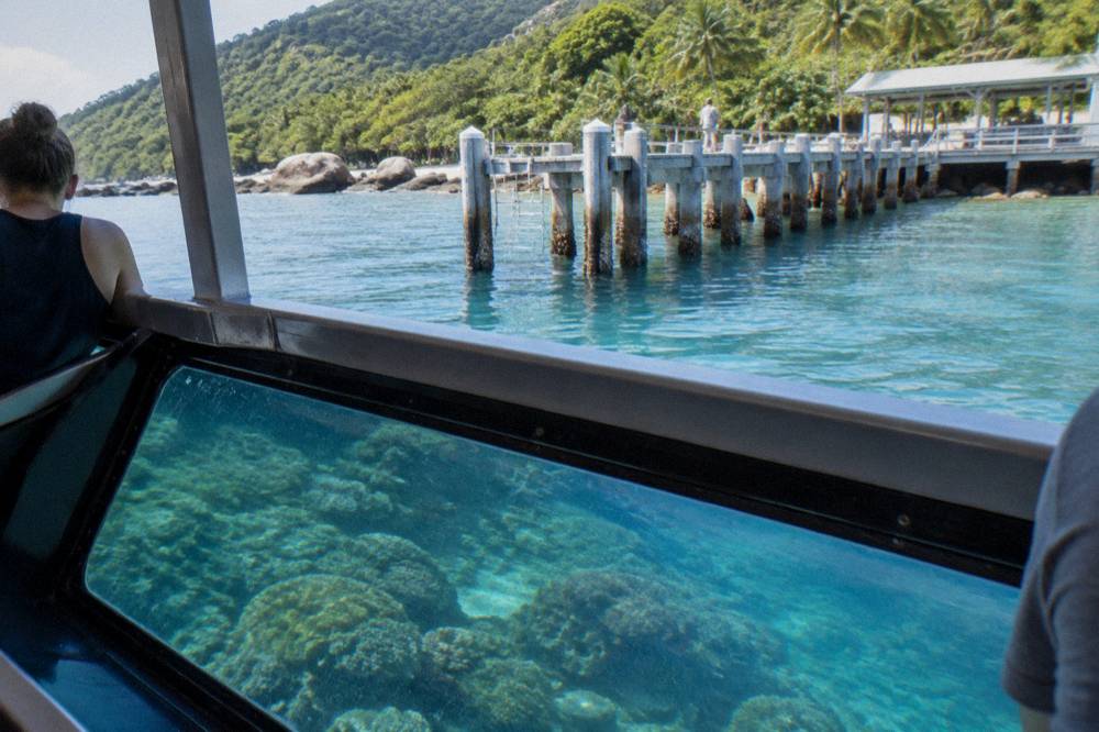 Glass-bottom boat drifting over coral reef near Fitzroy Island